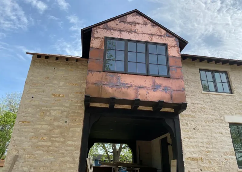 Copper metal panel facade on a stone building for Metal Roof Coating in Picayune