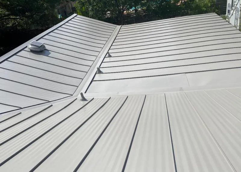 Solar attic fan installed on a metal roof for Roof Ventilation in Picayune